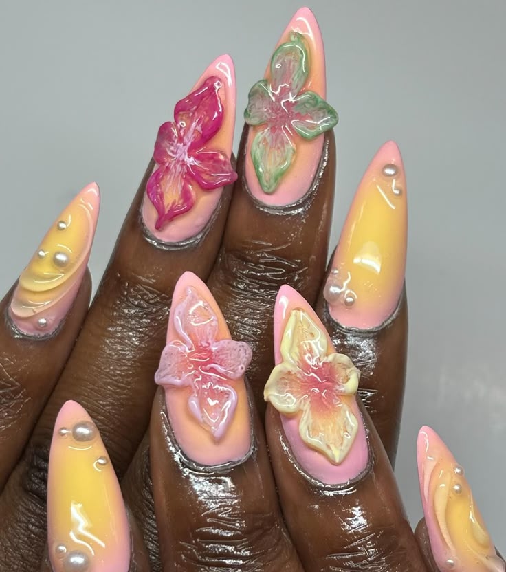 vibrant pink and yellow spring nail design on acrylic nails