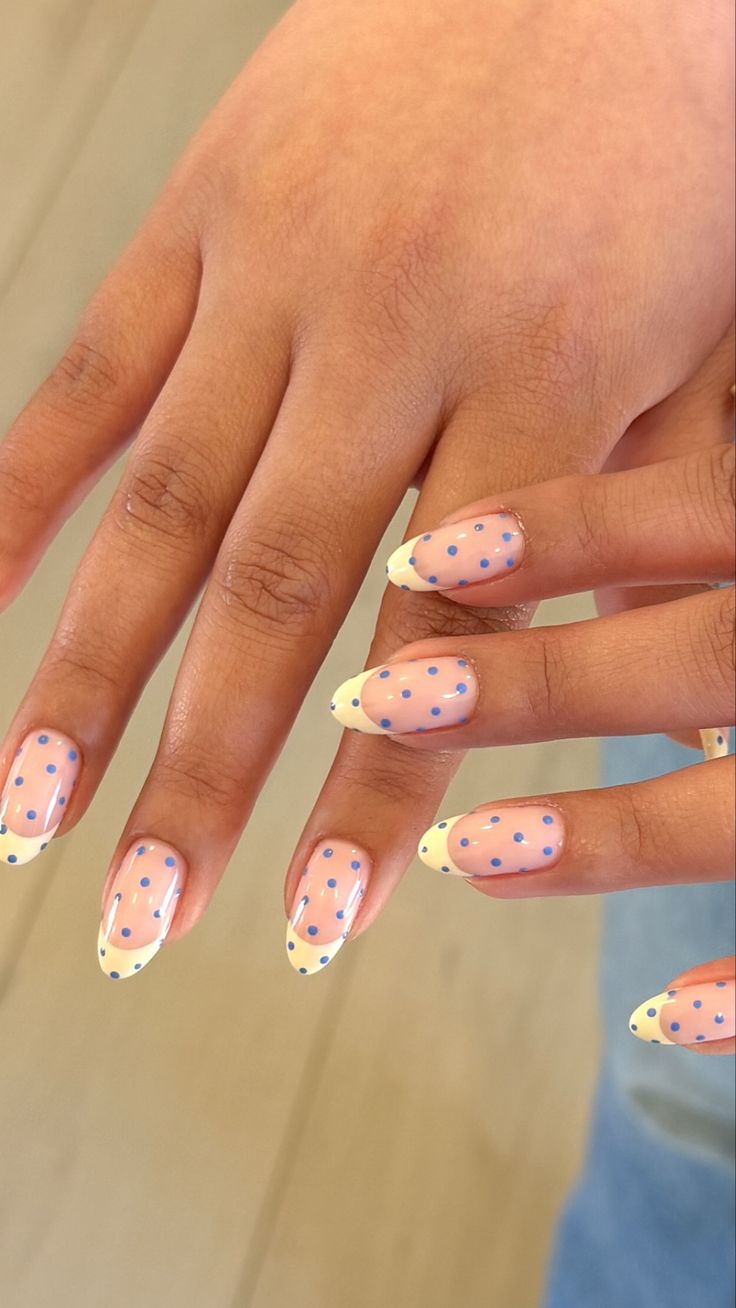 woman with polka dot nail design on hands